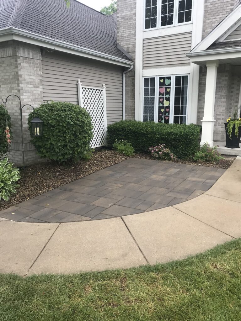 Suburban home entrance with landscaped walkway.